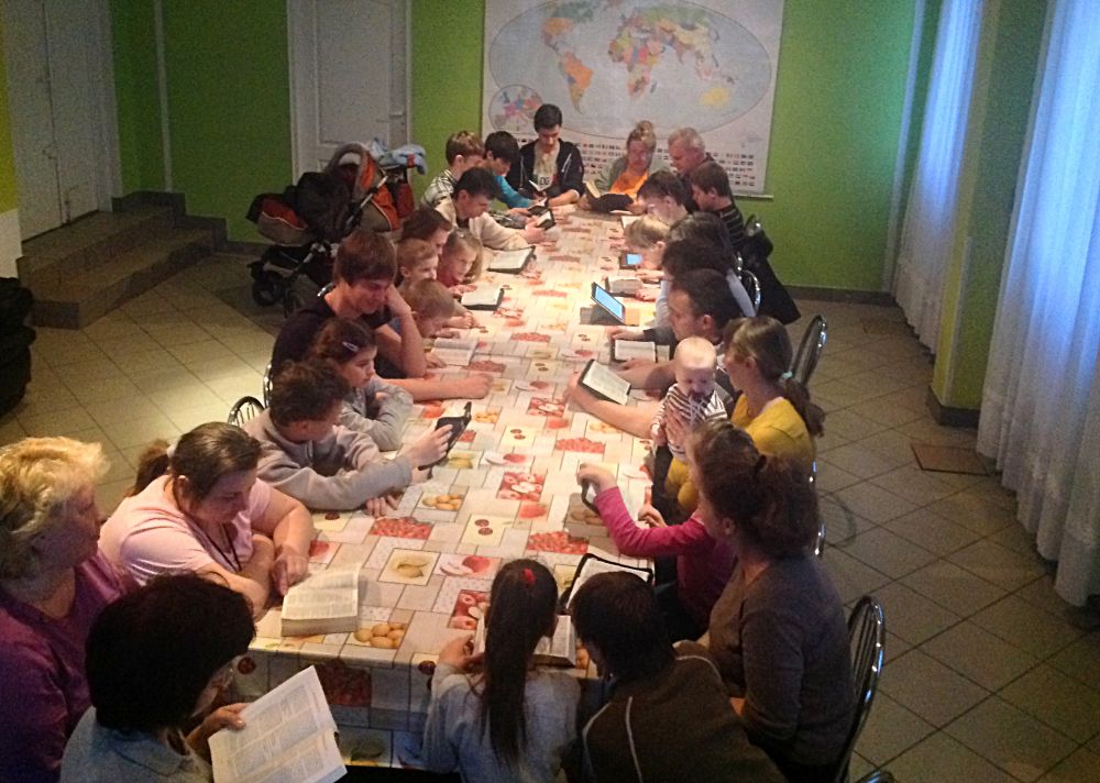 W piątkowy wieczór grupa uchodźców wspólnie czytała biblię.